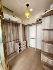 Spacious walk-in closet with wooden shelves and hanging space