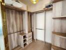 Spacious walk-in closet with wooden shelves and hanging space