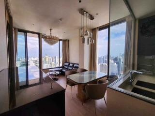 Modern living room with city view, dining area, and open kitchen