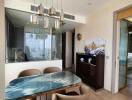 Modern dining area with glass table and elegant seating