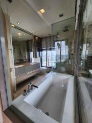 Modern bathroom with large bathtub and glass-enclosed shower