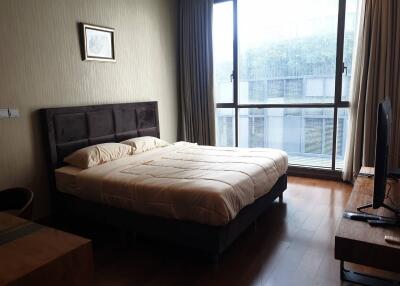 Bedroom with large window and bed