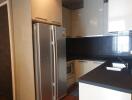 Modern kitchen with stainless steel fridge and sleek cabinetry