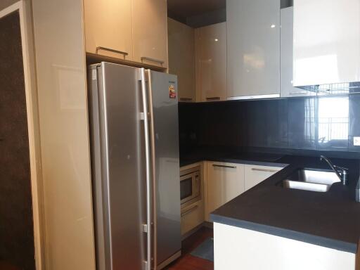 Modern kitchen with stainless steel fridge and sleek cabinetry