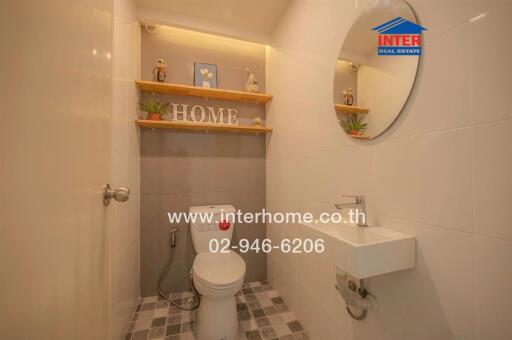 Small bathroom with decorative shelving and essential fixtures