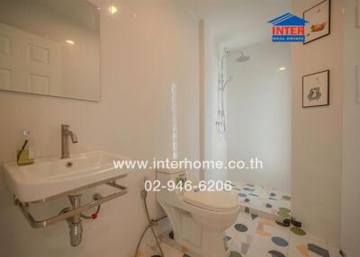 Modern bathroom with white tiles and walk-in shower