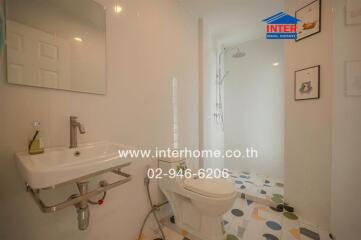 Modern bathroom with white tiles and walk-in shower