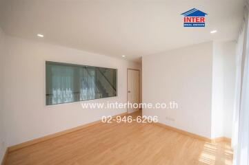 Spacious living room with wooden flooring and large window