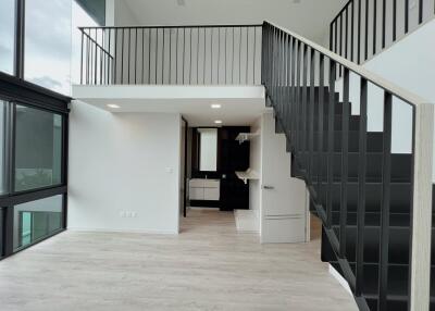 Modern living area with loft and stairs