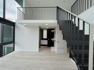 Modern living area with loft and stairs