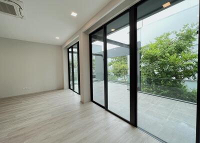 Spacious living area with large glass sliding doors to outdoor balcony