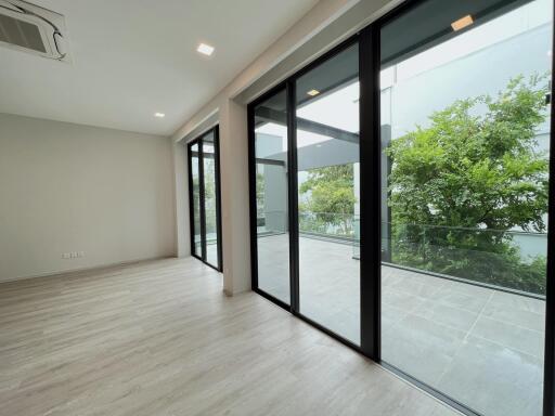 Spacious living area with large glass sliding doors to outdoor balcony