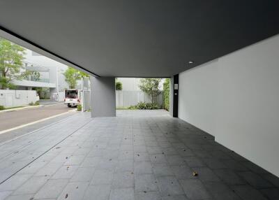 A spacious, modern garage with a partially covered outdoor area