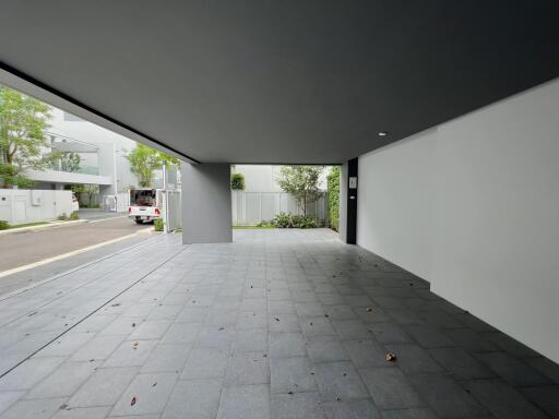 A spacious, modern garage with a partially covered outdoor area