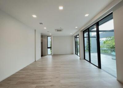 Bright and spacious living room with large windows and modern lighting