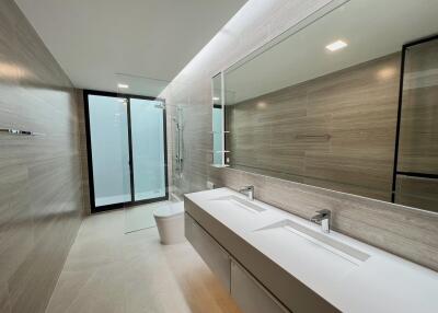 Modern bathroom with double sink and walk-in shower