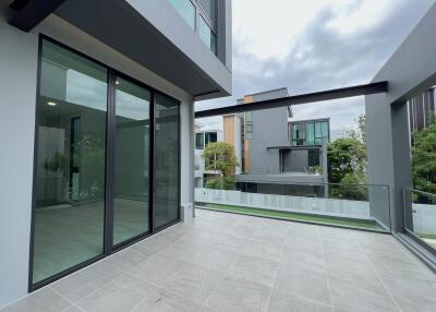 Modern balcony with glass railing and spacious tiled floor