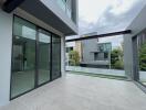 Modern balcony with glass railing and spacious tiled floor