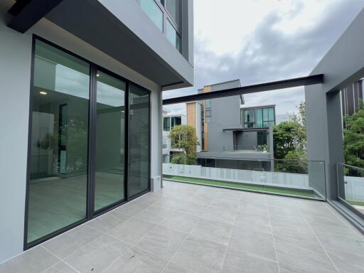 Modern balcony with glass railing and spacious tiled floor