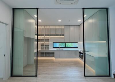 Modern kitchen with glass doors and built-in appliances