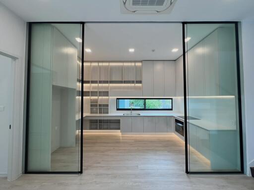 Modern kitchen with glass doors and built-in appliances