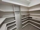 Spacious walk-in closet with built-in shelves and drawers