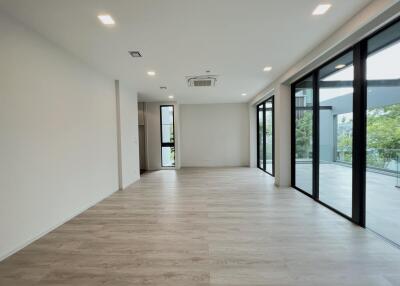 Spacious living room with large windows and sliding glass doors.