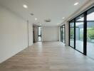 Spacious living room with large windows and sliding glass doors.