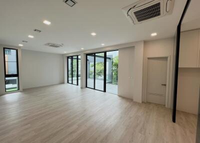 Spacious and bright living room with large windows and modern lighting fixtures