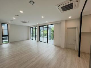 Spacious and bright living room with large windows and modern lighting fixtures