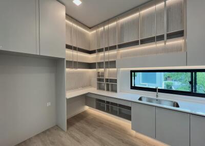 Modern kitchen with ample storage, countertop space, and a large window