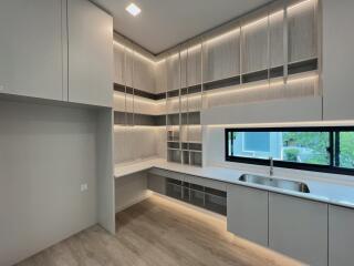 Modern kitchen with ample storage, countertop space, and a large window