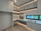 Modern kitchen with ample storage, countertop space, and a large window