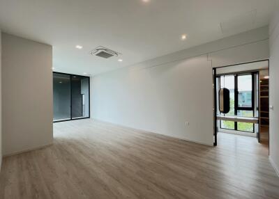 Spacious modern living room with wooden flooring and large windows