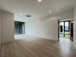 Spacious modern living room with wooden flooring and large windows