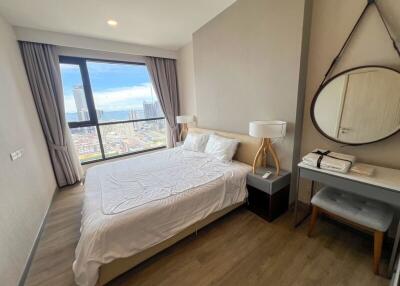 Modern bedroom with large window and city view