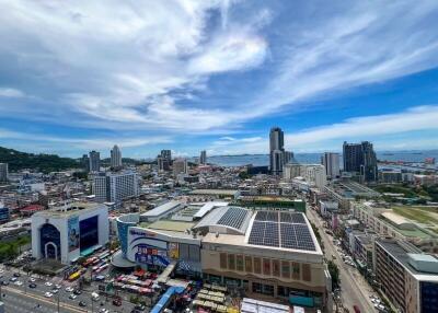 Panoramic view of the city with buildings and ocean in the background