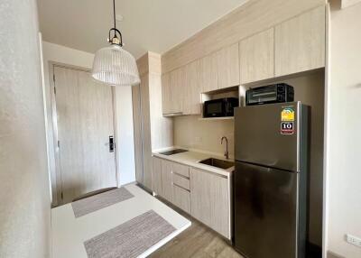 Modern apartment kitchen with appliances and dining area