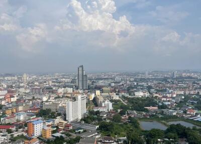 High-rise view from apartment with cityscape and cloudy sky