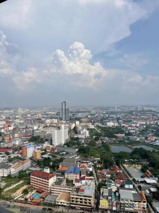 High-rise view from apartment with cityscape and cloudy sky