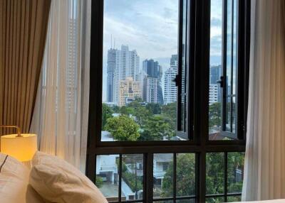 Bedroom with city view from window