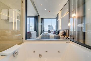 Modern bathroom with a view into the bedroom