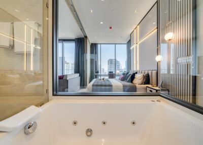 Modern bedroom with city view and luxurious bathtub