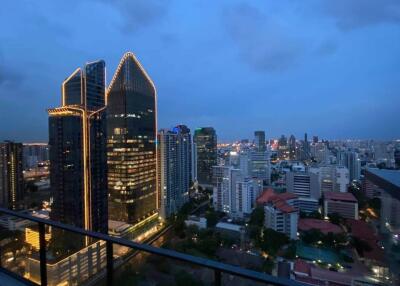 Nighttime cityscape with illuminated office buildings