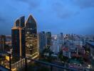 Nighttime cityscape with illuminated office buildings