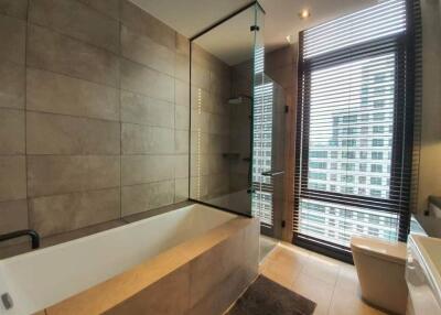 Modern bathroom with a large window and city view