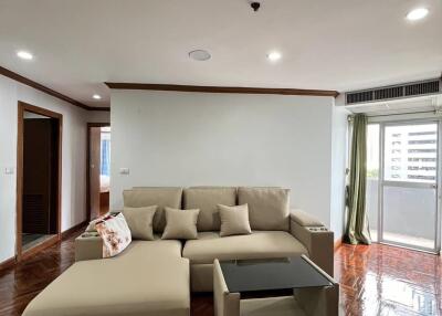 spacious living room with beige sofa and glass coffee table