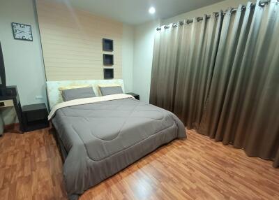 Bedroom with wood flooring and large bed