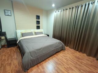 Bedroom with wood flooring and large bed