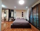 Spacious modern bedroom with wooden flooring, large windows, and ample storage